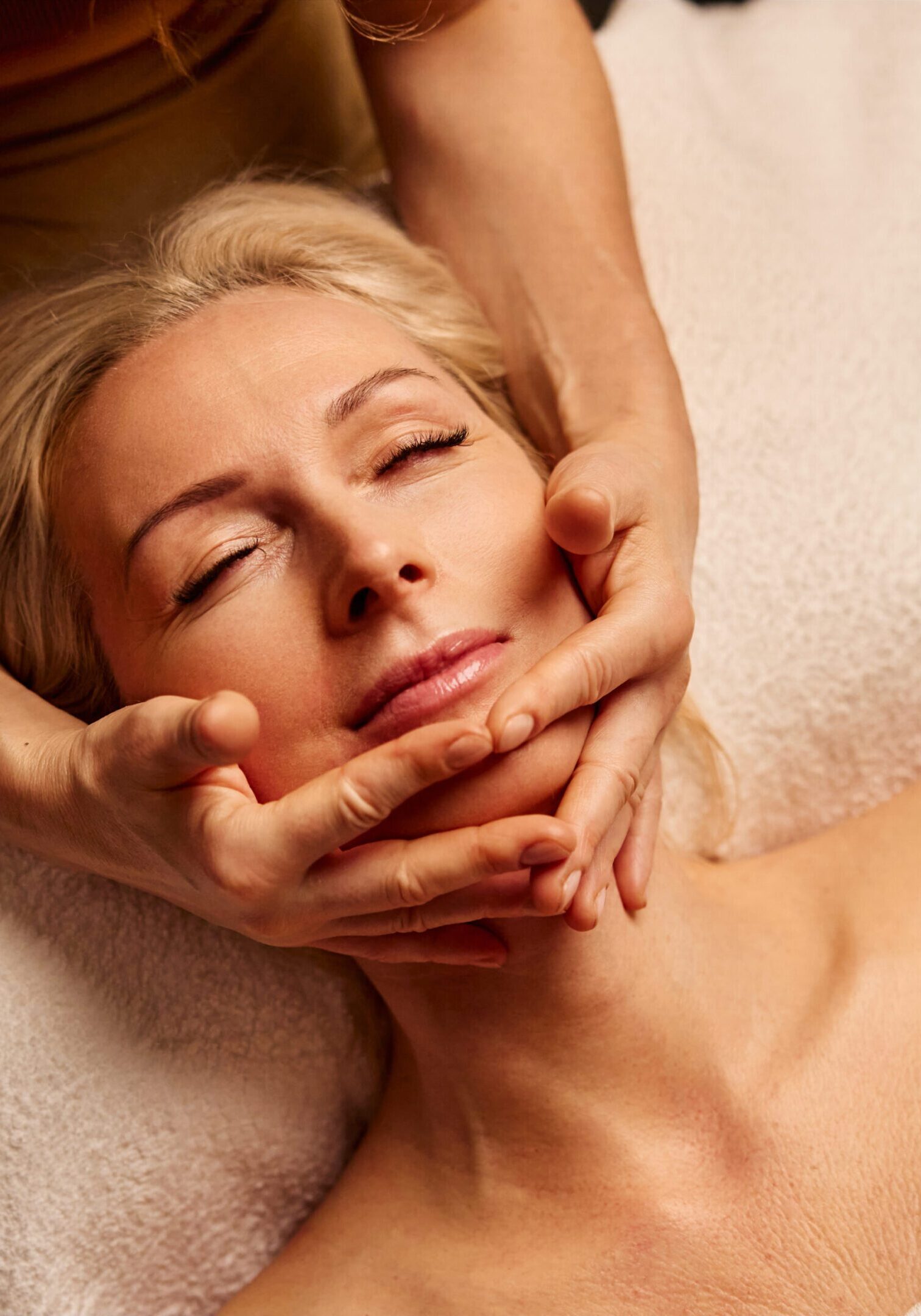 Serene Spa Experience with Relaxing Facial Massage Serene Spa Experience with Relaxing Facial Massage. A woman enjoys a calming spa treatment with a gentle facial massage
